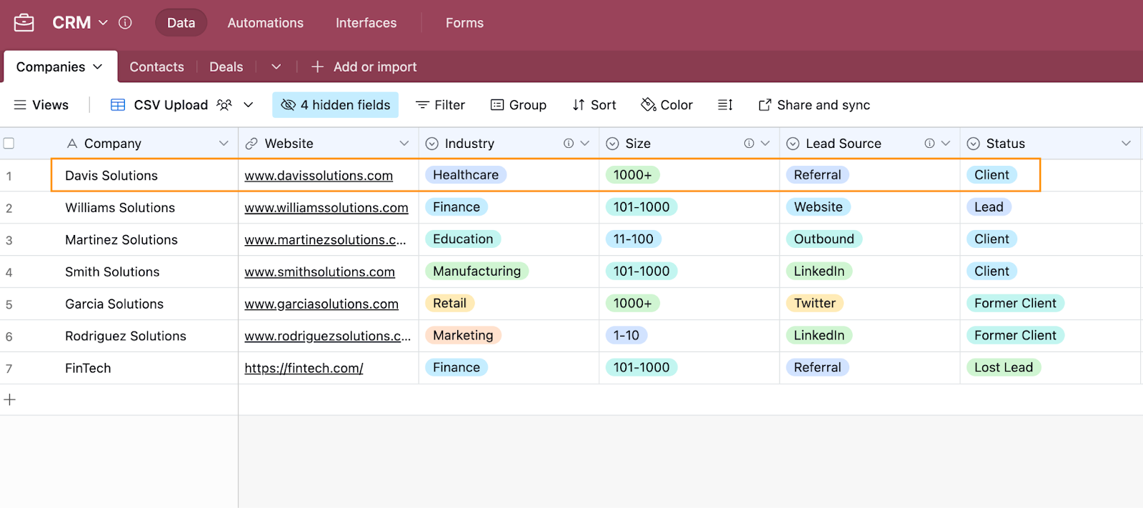 An Airtable database entitled CRM with the row for the company Davis Solutions highlighted.